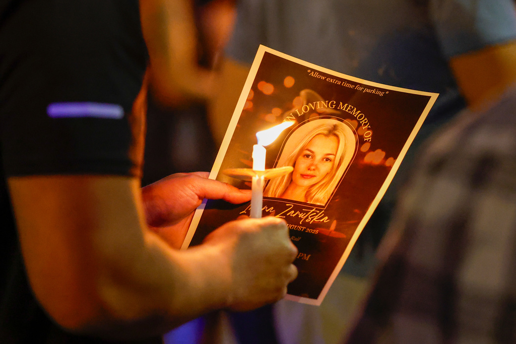 FILE - Community members gather for a vigil honoring the life of Iryna Zarutska, a Ukranian refugee, who was fatally stabbed on a commuter train, Sept. 22, 2025, in Charlotte, N.C. (AP Photo/Nell Redmond, File)