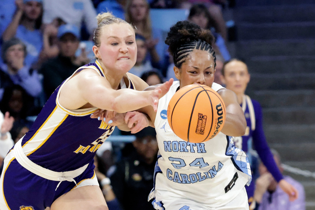 Western Illinois forward Mia Nicastro, left, and North Carolina guard Indya Nivar (24) battle for the ball during the first half in the first round of the NCAA college basketball tournament Friday, March 20, 2026, in Chapel Hill, N.C. (AP Photo/Chris Seward)