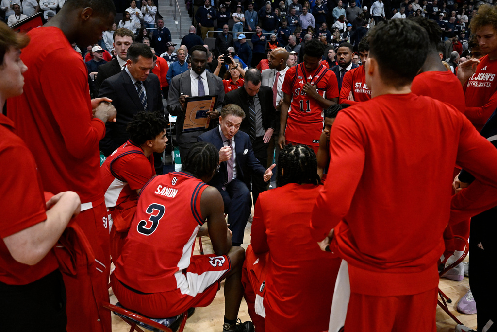 St. John's head coach Rick Pitino, center, talks to his team in the first half of an NCAA college basketball game against UConn, Wednesday, Feb. 25, 2026, in Hartford, Conn. (AP Photo/Jessica Hill)