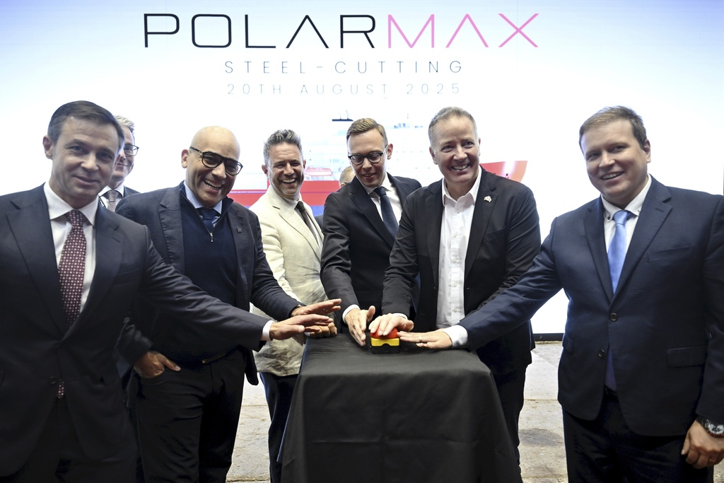 Canada's and Finland's representatives pose for a group photo during a steel cutting ceremony for the beginning of construction of the Polar Max Icebreaker in Helsinki Shipyard in Helsinki, Finland, Wednesday, Aug. 20, 2025. (Markku Ulander/Lehtikuva via AP)