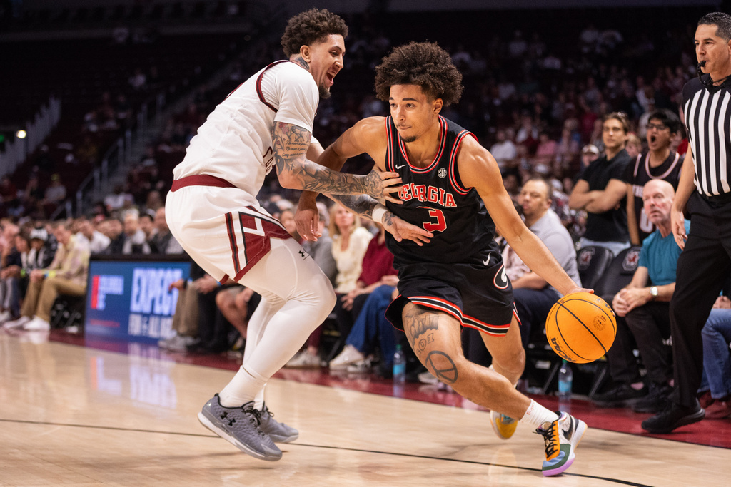 Georgia guard Jordan Ross (3) drives on South Carolina forward Myles Stute (10) during the first half of an NCAA college basketball game Saturday, Jan. 10, 2026, in Columbia, S.C. (AP Photo/Scott Kinser)