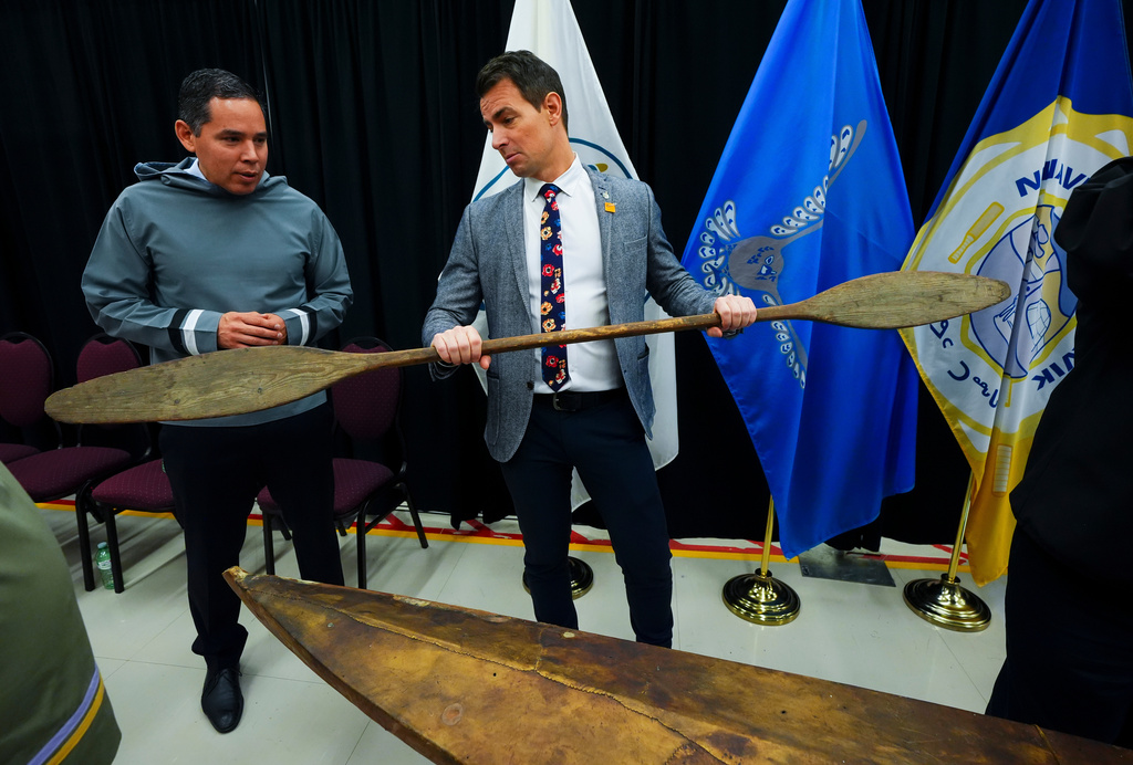 Natan Obed, President of Inuit Tapiriit Kanatami, left, stands with Adam van Koeverden, Secretary of State (Sport) and gold medal Olympic kayaker, as a selection of Inuit items, including a traditionally built Inuvialuit kayak and paddle, are unveiled at the Canadian Museum of History in Gatineau, Que., on Tuesday, Dec. 9, 2025. (Sean Kilpatrick /The Canadian Press via AP)