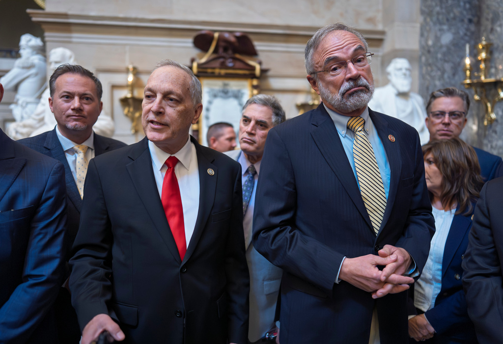 After a deal was approved to fund the Department of Homeland Security, except for immigration operations, members of the conservative House Freedom Caucus, including Rep. Andy Biggs, R-Ariz., left, and Rep. Andy Harris, R-Md., right, tell reporters that they won't vote in the House to pass it as is, at the Capitol in Washington, Friday, March 27, 2026. (AP Photo/J. Scott Applewhite)