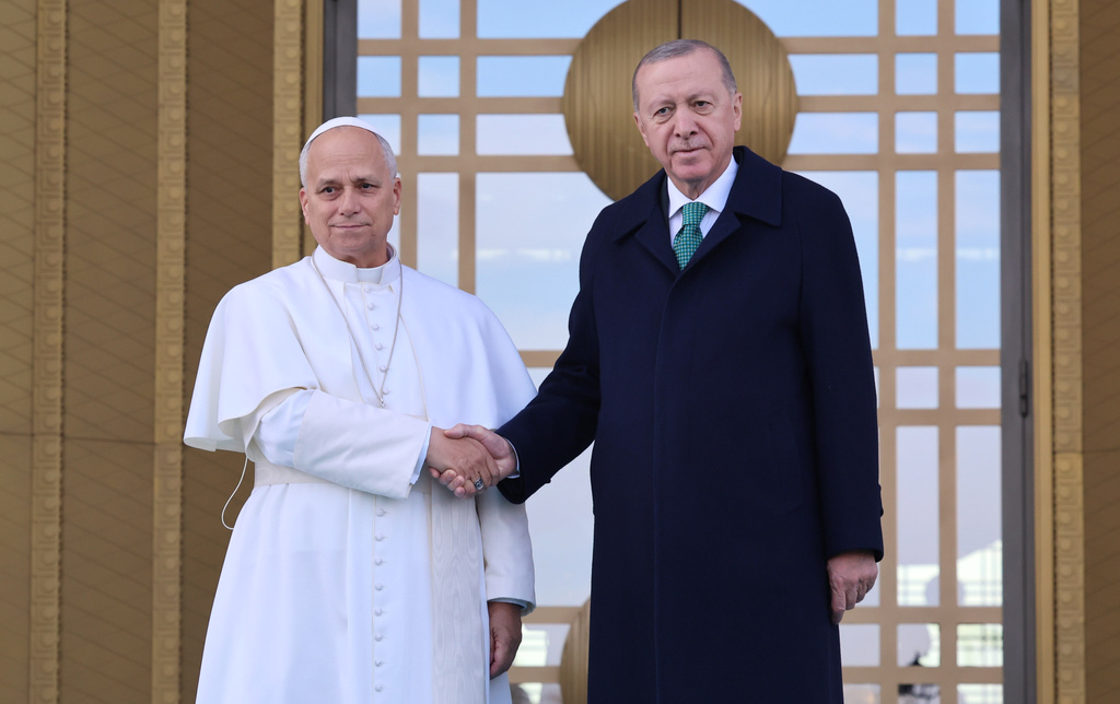 Pope Leo XIV, left, shakes hands with Turkey's President Recep Tayyip Erdogan before their meeting at the presidential palace, in Ankara, Turkey, Thursday, Nov. 27, 2025, during the first of his six-day trip to Turkey and Lebanon. (Yavuz Ozden/Dia Photo via AP)