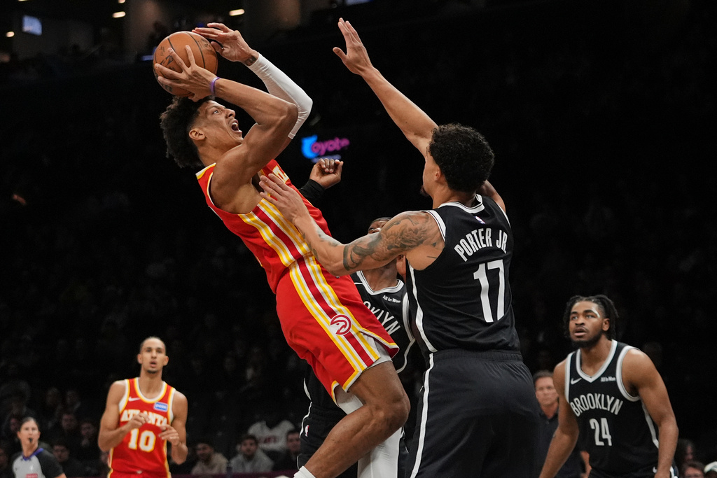 Atlanta Hawks' Jalen Johnson shoots over Brooklyn Nets' Michael Porter Jr., right, during the first half of an NBA basketball game Wednesday, Oct. 29, 2025, at Barclays Center in New York. (AP Photo/Frank Franklin II)