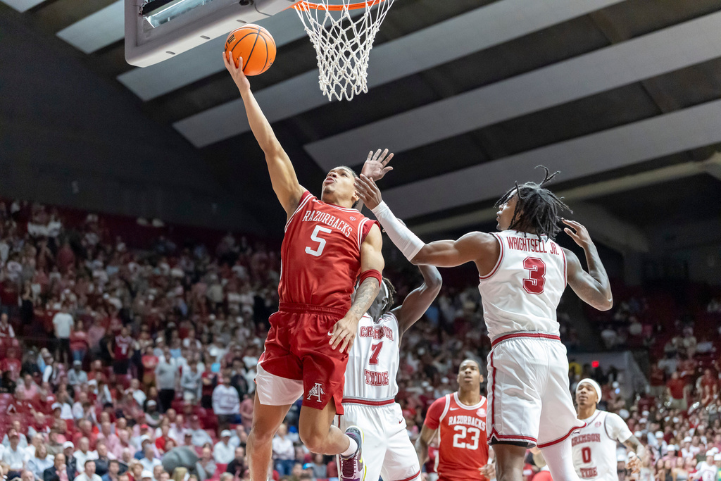 Arkansas guard Darius Acuff Jr. (5) gets past Alabama guard Latrell Wrightsell Jr. (3) for a shot during the first half of an NCAA college basketball game Wednesday, Feb. 18, 2026, in Tuscaloosa, Ala. (AP Photo/Vasha Hunt)
