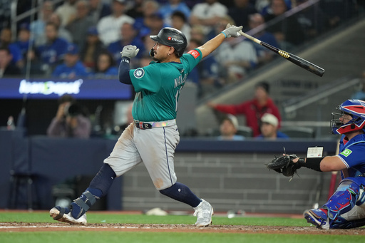 Seattle Mariners' Josh Naylor, left, watches his home run during the seventh inning of Game 2 of baseball's American League Division Series against the Toronto Blue Jays in Toronto, Monday, Oct. 13, 2025. (Nathan Denette/The Canadian Press via AP) Seattle Mariners' Josh Naylor, left, watches his home run during the seventh inning of Game 2 of baseball's American League Division Series against the Toronto Blue Jays in Toronto, Monday, Oct. 13, 2025. (Nathan Denette/The Canadian Press via AP)