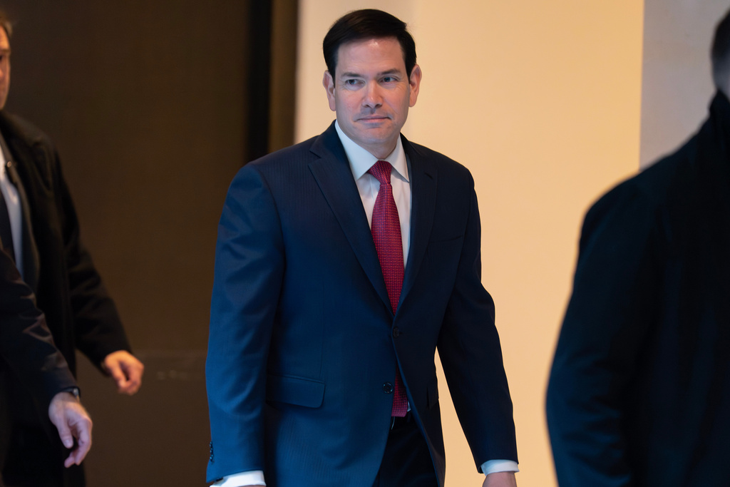 Secretary of State Marco Rubio walks to a secure room in the basement of the Capitol to brief senators on military strikes near Venezuela, Tuesday, Dec. 16, 2025, in Washington. (AP Photo/Jose Luis Magana)
