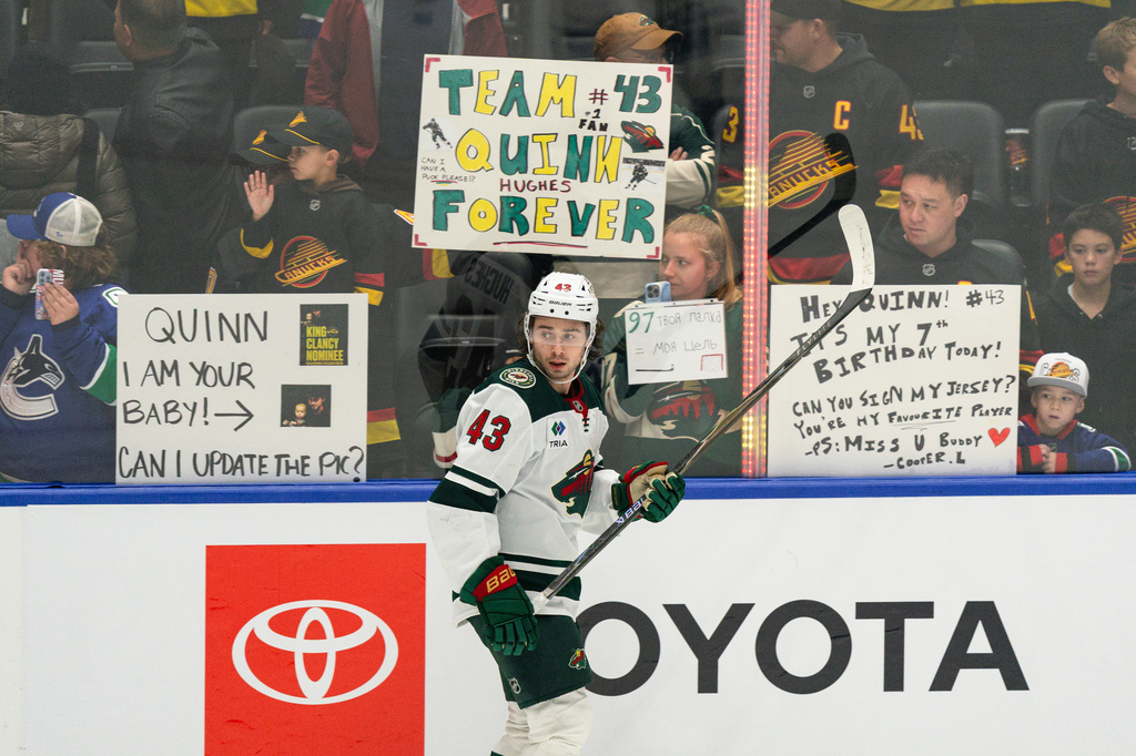 Fans watch as Minnesota Wilds' Quinn Hughes (43) participates in the pre-game skate before an NHL hockey game against his former team, the Vancouver Canucks, in Vancouver, British Columbia, Sunday, Oct. 25, 2026. (Jacob Mallari/The Canadian Press via AP)