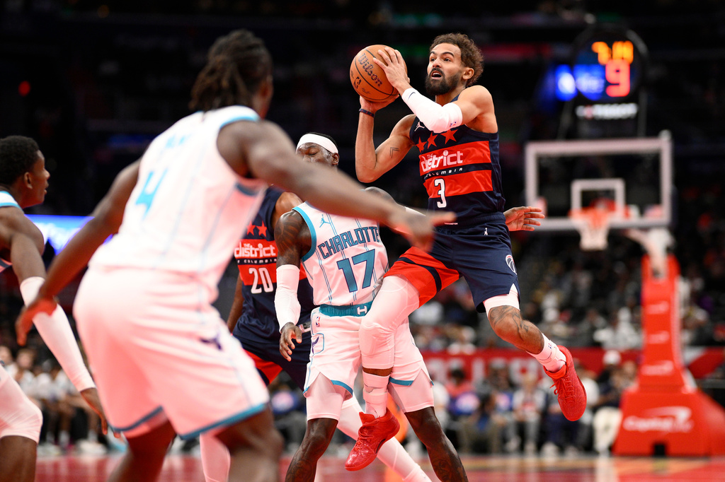 Washington Wizards guard Trae Young (3) looks to pass the ball against Charlotte Hornets guard Dennis Schroder (17) during the first half of an NBA Cup basketball game, Friday, Oct. 30, 2026, in Washington. (AP Photo/Nick Wass)
