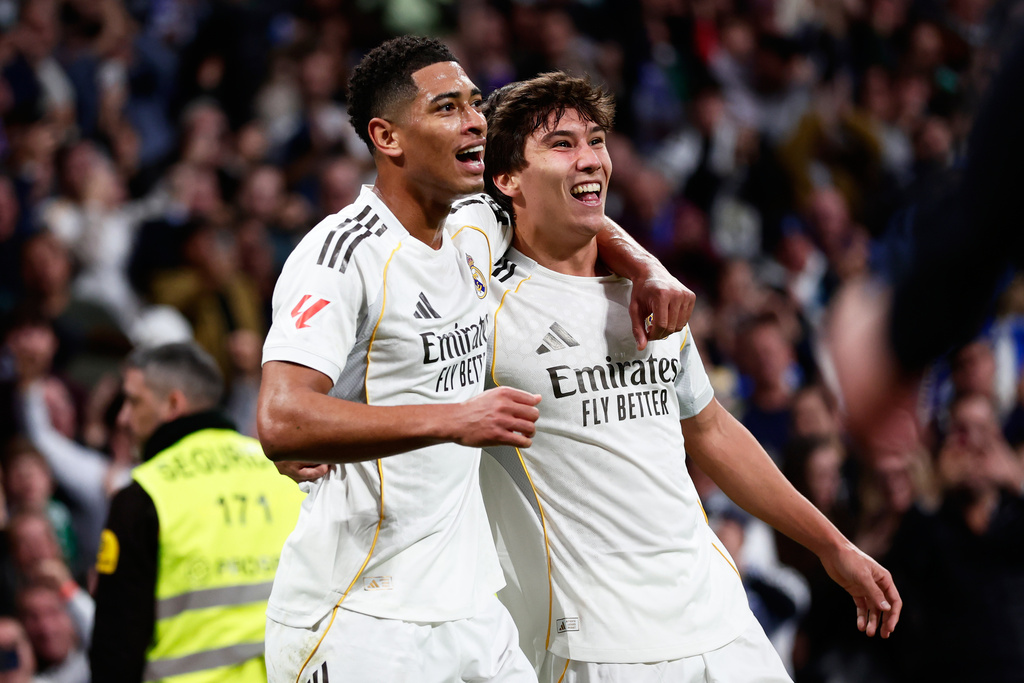 Real Madrid's Gonzalo Garcia, right, celebrates with Real Madrid's Jude Bellingham after scoring his sides first goal during the Spanish La Liga soccer match between Real Madrid and Real Betis Sevilla in Madrid, Spain, Sunday, Jan. 4, 2026. (AP Photo/Pablo Garcia)