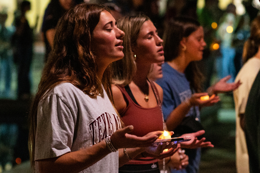 Attendees sing during the worship portion of the vigil for Charlie Kirk at Rudder Plaza on the Texas A&M Campus in College Station, Texas, Thursday, Sept. 11, 2025. (Meredith Seaver/College Station Eagle via AP)