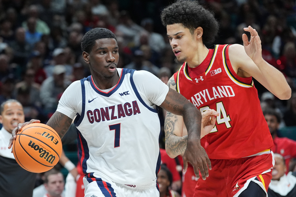 Gonzaga guard Tyon Grant-Foster (7) drives around Maryland forward Aleks Alston (24) during the first half of an NCAA college basketball game in the Players Era tournament Las Vegas, Tuesday, Nov. 25, 2025. (AP Photo/Eric Gay)