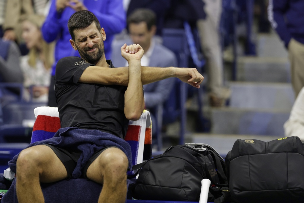 Novak Djokovic, of Serbia, stretches between sets against Taylor Fritz, of the United States, during the quarterfinal round of the U.S. Open tennis championships, Tuesday, Sept. 2, 2025, in New York. (AP Photo/Adam Hunger)