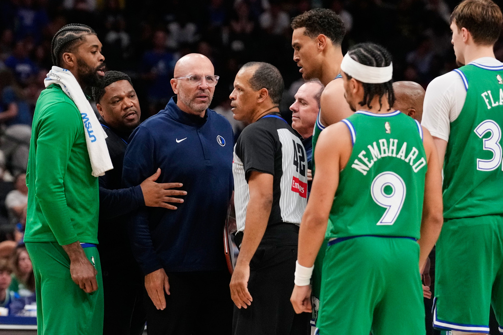 Dallas Mavericks head coach Jason Kidd, center, left, talks to Eric Lewis (42) after Kidd was ejected in the second half of an NBA basketball game against the Orlando Magic Friday, April 3, 2026, in Dallas. (AP Photo/Tony Gutierrez)