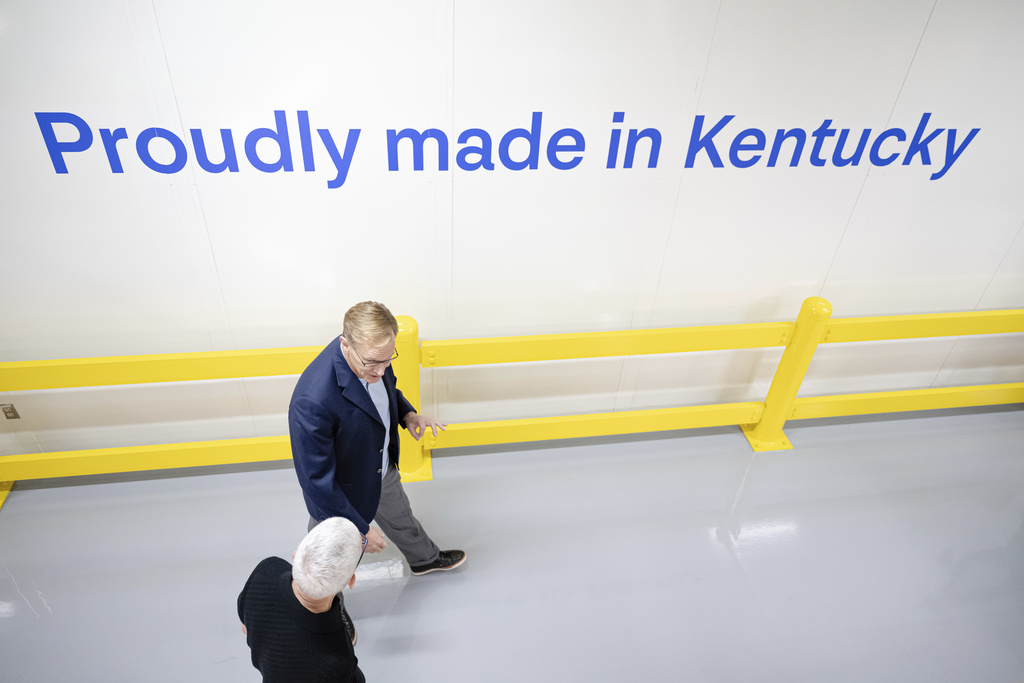 Apple CEO Tim Cook and Corning CEO Wendell Weeks walk during a tour of Corning's iPhone glass manufacturing facility Friday, Sept. 12, 2025, in Harrodsburg, Ky. (AP Photo/Jon Cherry)