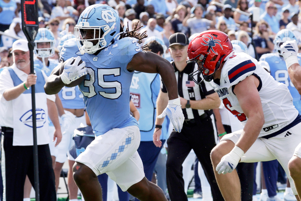 North Carolina running back Demon June (35) runs upfield against Richmond defensive lineman Camden Byrd (6) during the first half of an NCAA college football game Saturday, Sept. 13, 2025, in Chapel Hill, N.C. (AP Photo/Chris Seward)