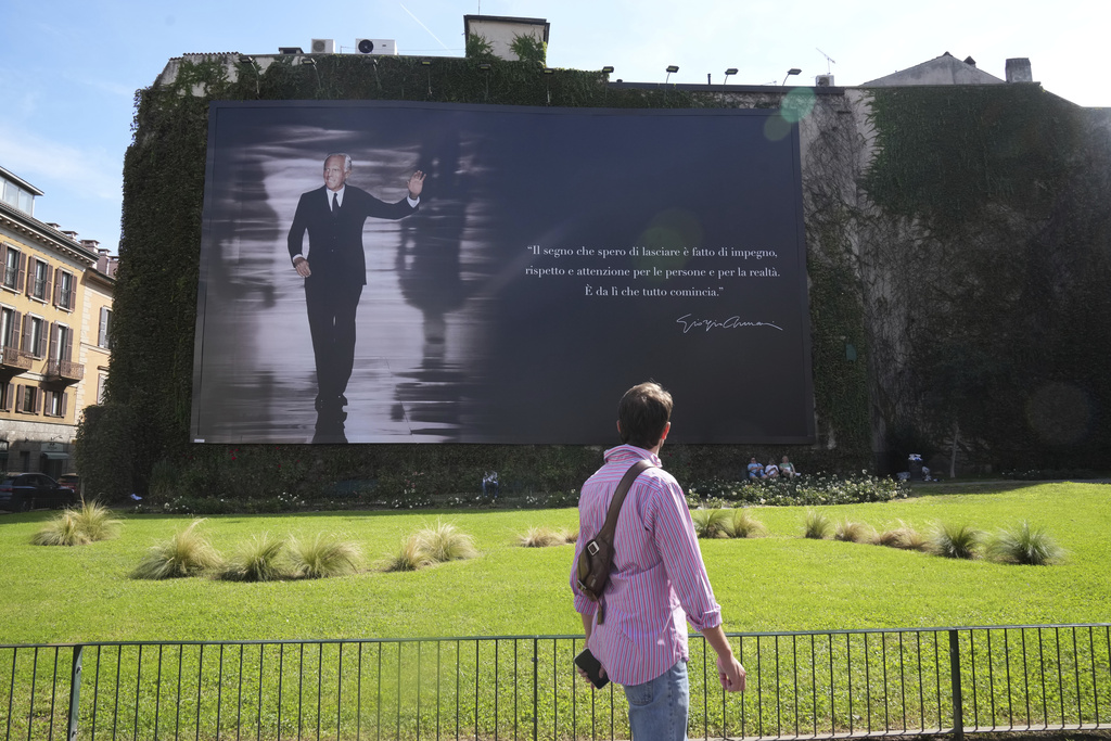 A giant memorial poster for designer Giorgio Armani, who died on Thursday at age 91, is set up in Milan, northern Italy, Sunday, Sept. 7, 2025. (AP Photo/Antonio Calanni)