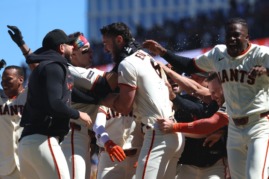 San Francisco Giants' Bryce Eldridge, center, celebrates with teammates after hitting a game winning grand slam against the Washington Nationals during the ninth inning of a baseball game in San Francisco, Wednesday, June 10, 2026. (AP Photo/Jed Jacobsohn)