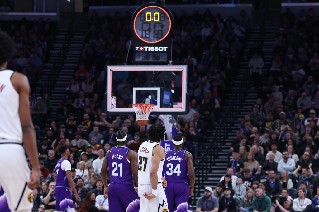 Denver Nuggets guard Jamal Murray (27) makes a three point basket from half court at the buzzer to end the first quarter of an NBA basketball game against the Utah Jazz, Wednesday, April 1, 2026, in Salt Lake City. (AP Photo/Rob Gray)