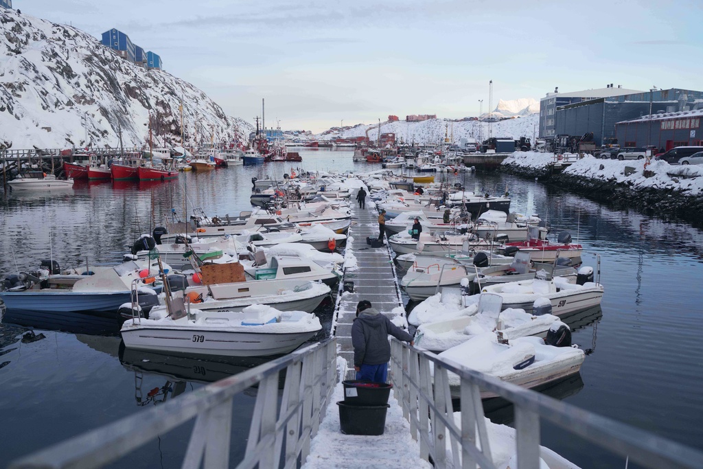 Fishermen arrive at the harbour of Nuuk, Greenland, Wednesday, Jan. 14, 2026. (AP Photo/Evgeniy Maloletka)