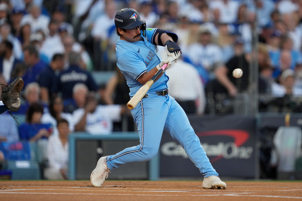 Toronto Blue Jays' Davis Schneider connects for a solo home run during the first inning in Game 5 of baseball's World Series against the Los Angeles Dodgers, Wednesday, Oct. 29, 2025, in Los Angeles. (AP Photo/Ashley Landis)