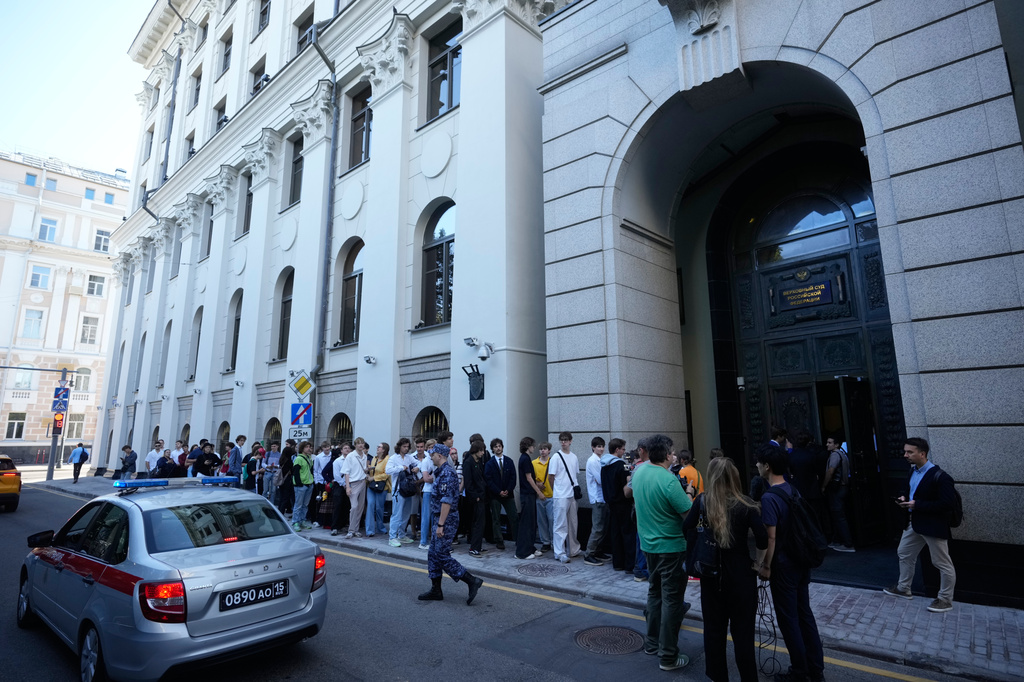 FILE - Supporters of the Yabloko party wait to enter Russia's Supreme Court in Moscow, Monday, Aug. 10, 2026, to attend a hearing on a lawsuit to bar the party from the ballot in the upcoming parliamentary election. (AP Photo/Pavel Bednyakov, File)