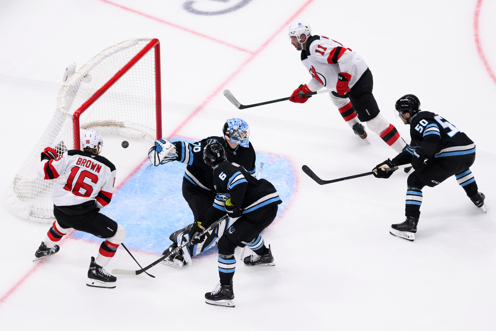 New Jersey Devils right wing Stefan Noesen scores a goal past Utah Mammoth goaltender Karel Vejmelka (70) during the third period of an NHL hockey game, Friday, Dec. 19, 2025, in Salt Lake City. (AP Photo/Tyler Tate)