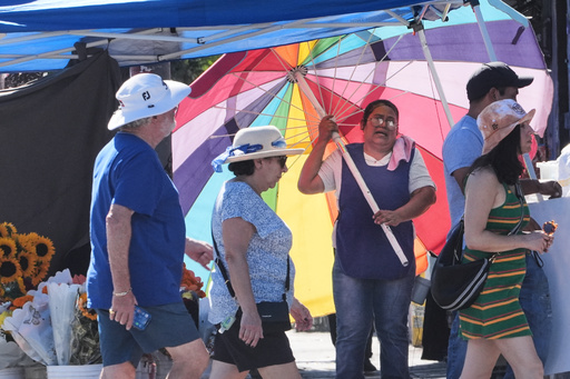 A street vendor uses an umbrella to shelter from the sun on a unseasonably hot day Tuesday, Oct. 28, 2025, in Los Angeles. (AP Photo/Damian Dovarganes) A street vendor uses an umbrella to shelter from the sun on a unseasonably hot day Tuesday, Oct. 28, 2025, in Los Angeles. (AP Photo/Damian Dovarganes)