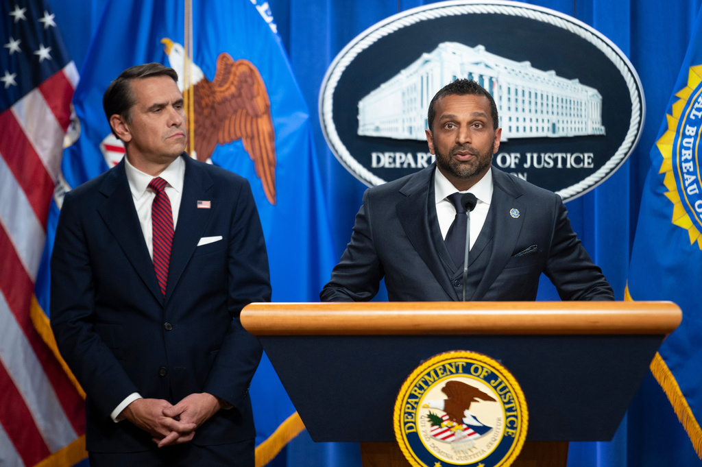 Acting Attorney General Todd Blanche, left, looks on as FBI Director Kash Patel speaks about former FBI Director James Comey indictment, at the Justice Department in Washington, Tuesday, April 28, 2026. (AP Photo/Cliff Owen)