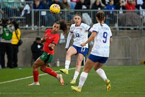 United States' Olivia Moultrie (13) passes the ball to teammate Ally Sentnor (9) as Portugal's Catarina Amado, left, defends during the second half of an international friendly women's soccer match, Sunday, Oct. 26, 2025, in East Hartford, Conn. (AP Photo/Jessica Hill) United States' Olivia Moultrie (13) passes the ball to teammate Ally Sentnor (9) as Portugal's Catarina Amado, left, defends during the second half of an international friendly women's soccer match, Sunday, Oct. 26, 2025, in East Hartford, Conn. (AP Photo/Jessica Hill)