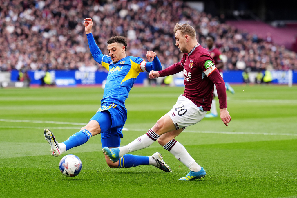 West Ham United's Jarrod Bowen, right, and Leeds United's Ethan Ampadu in action during the English FA Cup quarterfinal soccer match between West Ham United and Leeds United in London, Sunday April 5, 2026. (John Walton/PA via AP)
