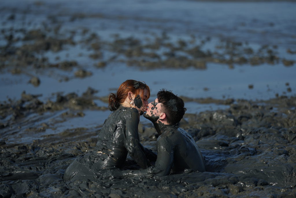 Revelers share a kiss during the Mud Block carnival party in Paraty, Brazil, Saturday, Feb. 14, 2026. (AP Photo/Andre Penner)
