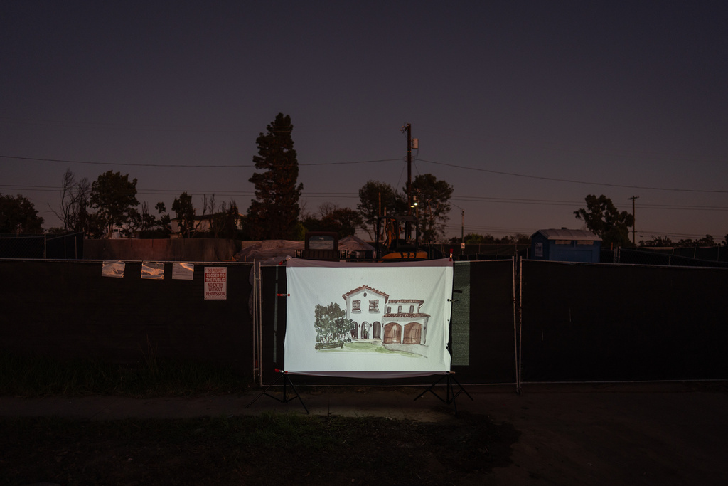 A design of Scott Quigley's home, as it will look after it is rebuilt, is projected on a screen on the property where his home destroyed in the Palisades Fire once stood in the Pacific Palisades neighborhood of Los Angeles, Friday, Dec. 5, 2025. (AP Photo/Jae C. Hong)