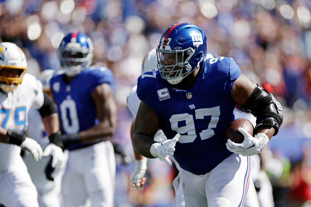 FILE - New York Giants defensive tackle Dexter Lawrence (97) returns an interception during an NFL football game against the Los Angeles Chargers, Sept. 28, 2025, in East Rutherford, N.J. (AP Photo/Adam Hunger, File)
