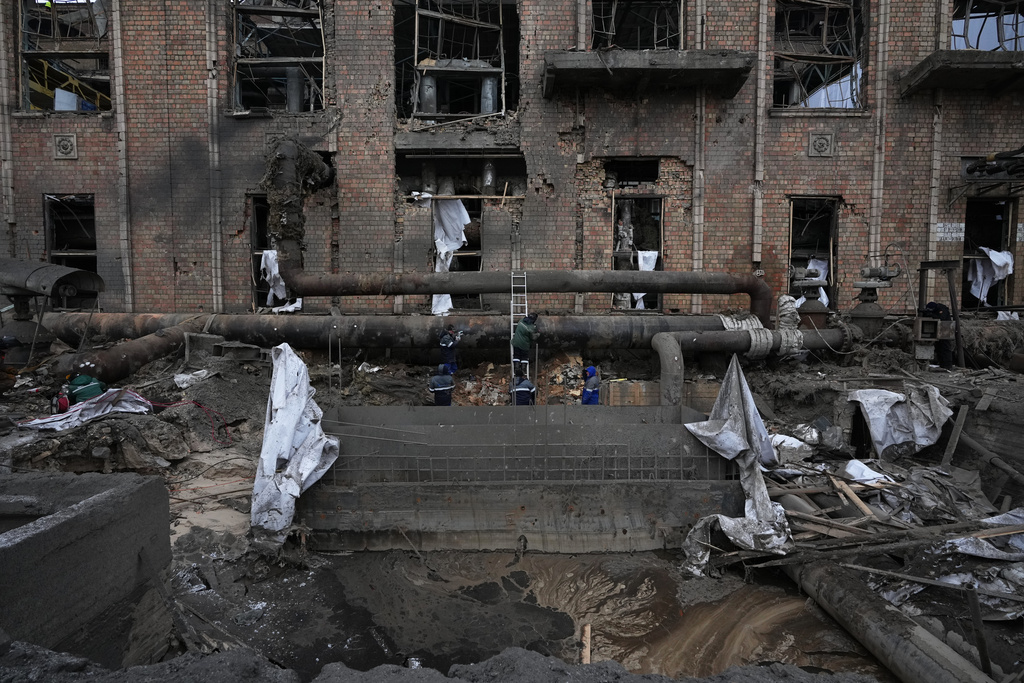 Workers clean up damage at Darnytsia Thermal Power Plant after a Russian attack in Kyiv, Ukraine, Wednesday, Feb. 4, 2026. (AP Photo/Sergei Grits)