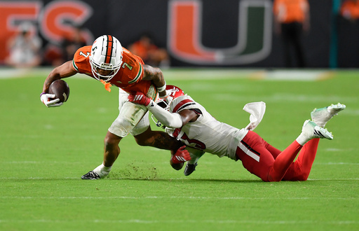 Miami wide receiver CJ Daniels (7) is tackled by Louisville cornerback Justin Agu during the second half of an NCAA college football game, Friday, Oct. 17, 2025, in Miami Gardens, Fla. (AP Photo/Michael Laughlin) Miami wide receiver CJ Daniels (7) is tackled by Louisville cornerback Justin Agu during the second half of an NCAA college football game, Friday, Oct. 17, 2025, in Miami Gardens, Fla. (AP Photo/Michael Laughlin)