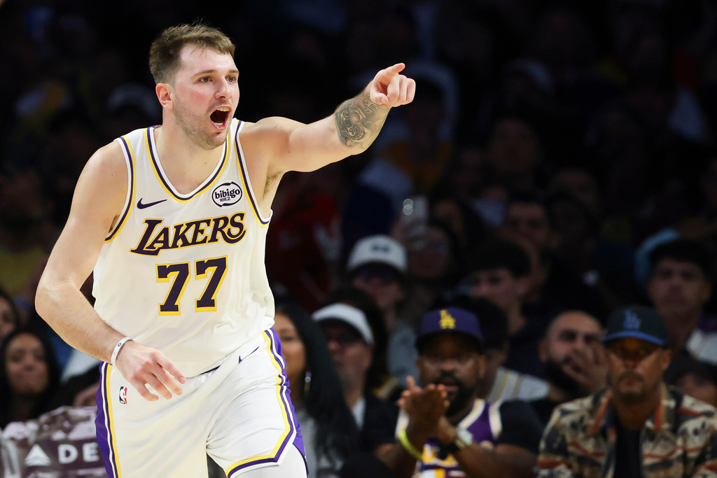 Los Angeles Lakers guard Luka Doncic (77) reacts after scoring a basket against the Miami Heat during the second half of an NBA basketball game, Sunday, Nov. 2, 2025, in Los Angeles. (AP Photo/Jessie Alcheh)