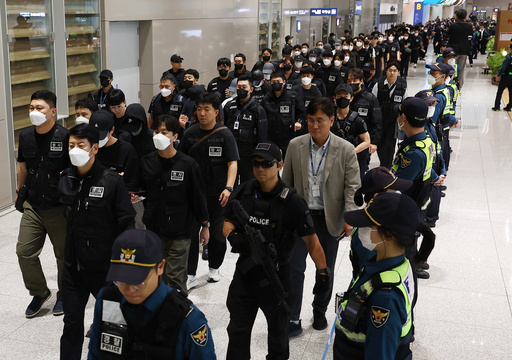 South Koreans, wearing caps, allegedly involved in online scams in Cambodia arrive at the Incheon International Airport, in Incheon, Saturday, Oct. 18, 2025. (Yonhap via AP) South Koreans, wearing caps, allegedly involved in online scams in Cambodia arrive at the Incheon International Airport, in Incheon, Saturday, Oct. 18, 2025. (Yonhap via AP)