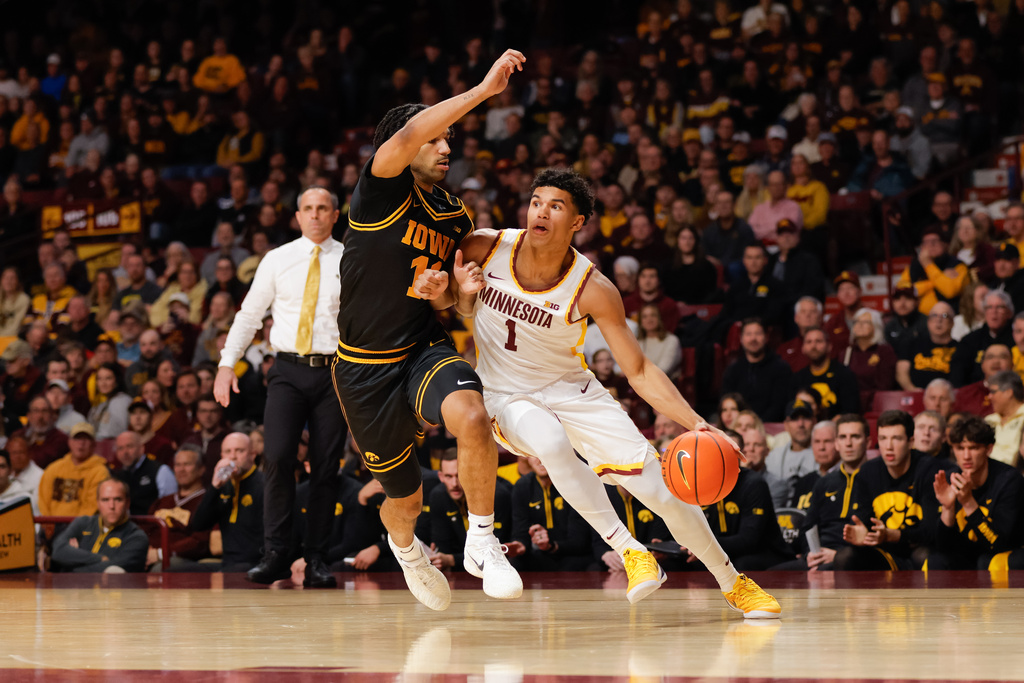 Minnesota Golden Gophers guard Isaac Asuma (1) drives to the basket while Iowa Hawkeyes guard Kael Combs defends during the first half of an NCAA college basketball game Tuesday, Jan. 6, 2026, in Minneapolis. (AP Photo/Bailey Hillesheim)