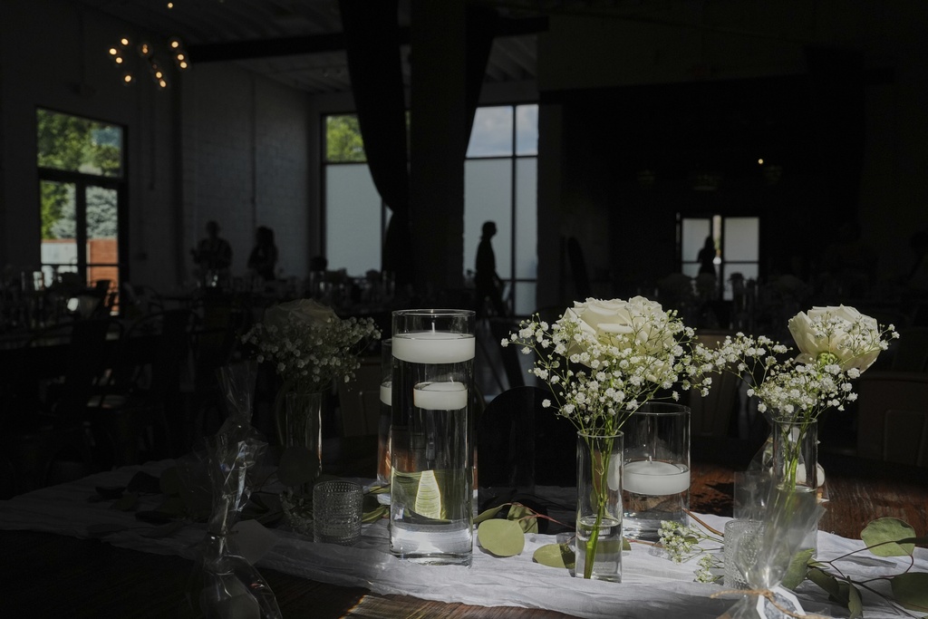 Sunlight falls on table decorations as guests arrive before a wedding Saturday, Aug. 23, 2025, in Newtown, Ohio. (AP Photo/Joshua A. Bickel)