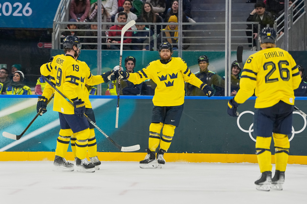 Sweden's William Nylander, center, celebrates after scoring her side's third goal during a preliminary round match of men's ice hockey between Italy and Sweden at the 2026 Winter Olympics, in Milan, Italy, Wednesday, Feb. 11, 2026. (AP Photo/Hassan Ammar)