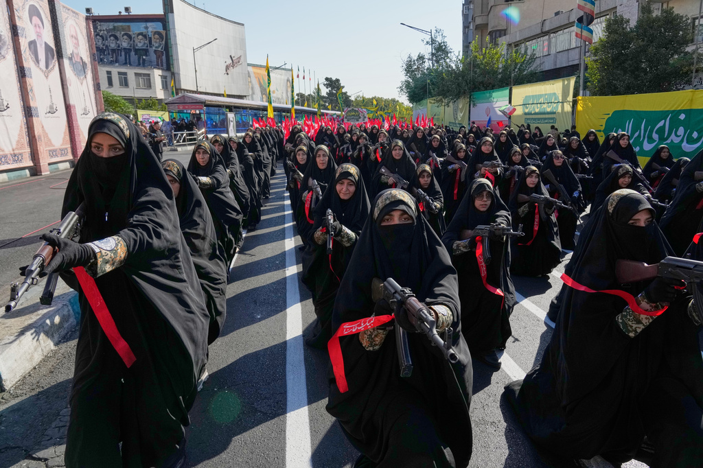 Women affiliated with Iran's Revolutionary Guard carry rifles as they stand during the state-organized "Janfada," or "Sacrifice for Iran," military-style parade in Tehran, Iran, Friday, Sept. 18, 2026. (AP Photo/Vahid Salemi)