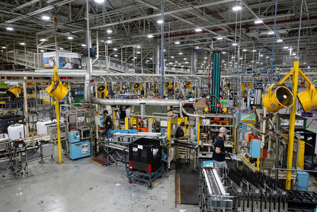 FILE - Employees piece together components on an assembly line at GE Appliances global headquarters, Aug 13, 2025, in Louisville, Ky. (AP Photo/Jon Cherry, file)