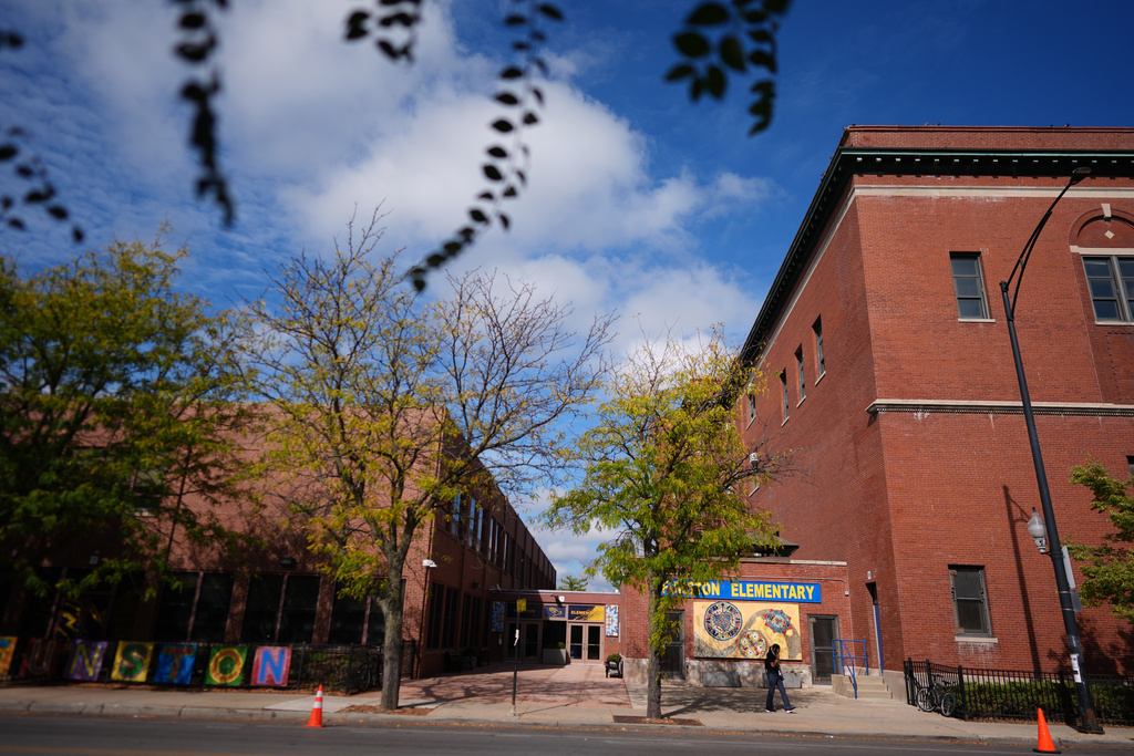A person walks past Funston Elementary School in Chicago's Logan Square neighborhood, Tuesday, Oct. 14, 2025. (AP Photo/Rebecca Blackwell)