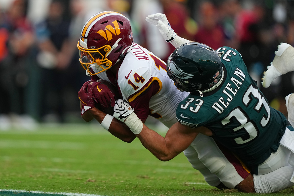 Washington Commanders wide receiver Antonio Williams (14) is stopped by Philadelphia Eagles cornerback Cooper DeJean (33) during the first half of an NFL football game, Sunday, Sept. 13, 2026, in Philadelphia. (AP Photo/Matt Rourke)