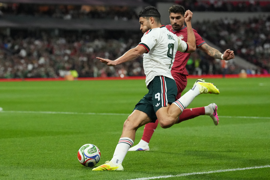 Mexico's Raul Jimenez, front, passes the ball during the international friendly soccer match between Mexico and Portugal in Mexico City, Saturday, March 28, 2026. (AP Photo/Eduardo Verdugo)