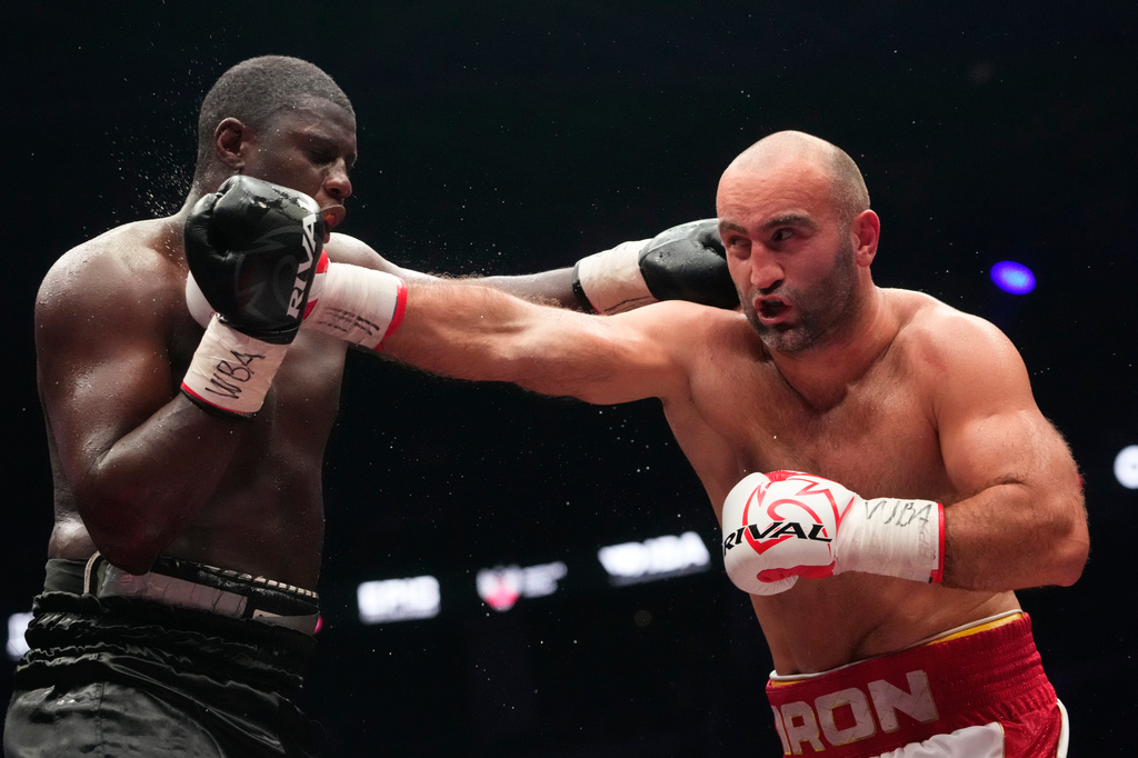 Russia's Murat Gassiev, right, lands a punch on Germany's Peter Kadiru during a WBA Heavyweight world title boxing match as part of the IBA Pro 19 event in Moscow, Russia, Saturday, July. 11, 2026. (AP Photo/Pavel Bednyakov)