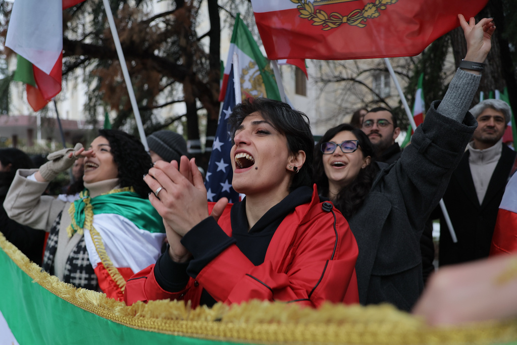 Iranian people attend a demonstration in support of the U.S. and Israeli strikes on Iran, at the Iranian Embassy in Tbilisi, Georgia, Sunday, March 1, 2026. (AP Photo/Zurab Tsertsvadze)