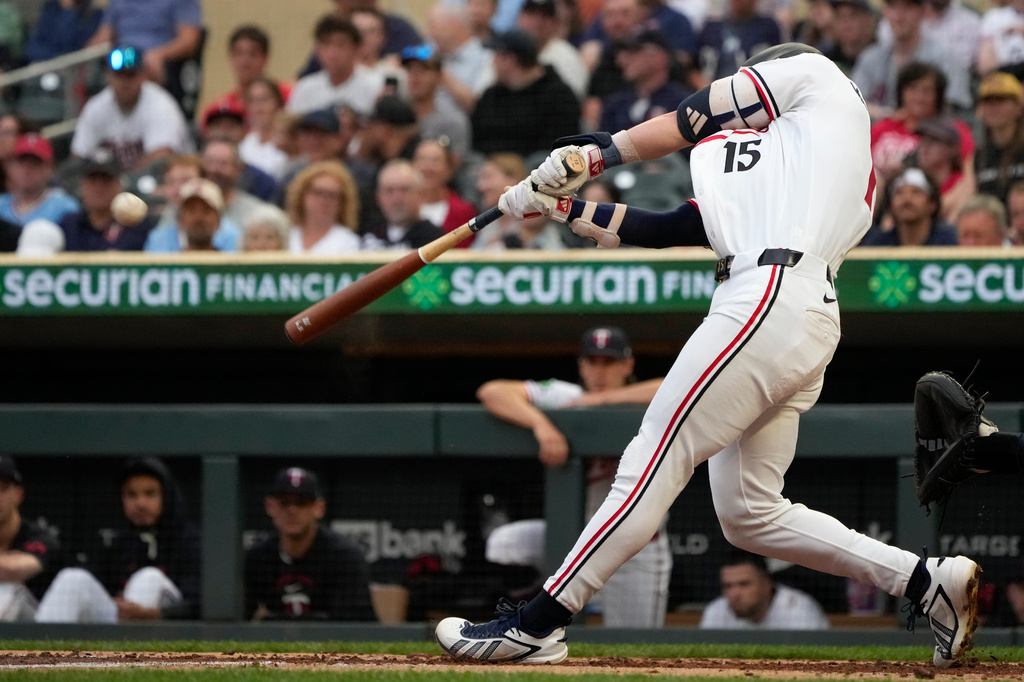 Minnesota Twins' Luke Keaschall (15) hits a sacrifice fly to score Kody Clemens during the fourth inning of a baseball game against the Cleveland Guardians, Wednesday, July 8, 2026, in Minneapolis. (AP Photo/Joseph Scheller)